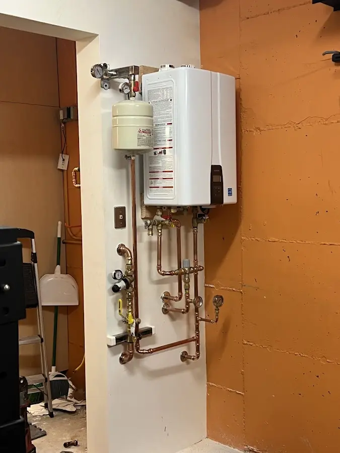 Plumbing technician inspecting water heater connections in Bethlehem